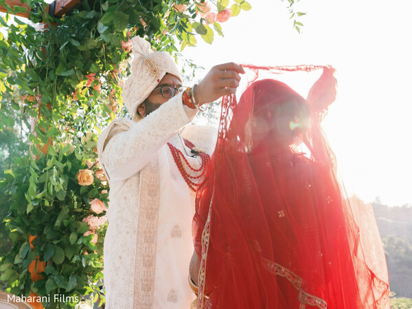 wedding ceremony,red fabric,floral arch,wedding attire