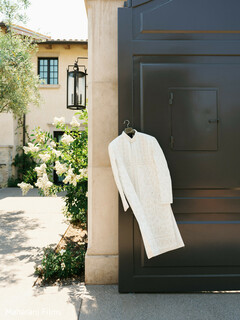 White Embroidered Kurta Hanging on a Gate