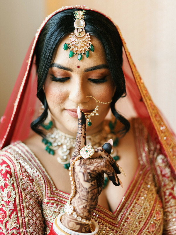 south asian wedding,bridal portrait,red lehenga,emerald jewelry,gold jewelry,intricate mehndi,bridal makeup,nose ring,bridal fashion,wedding jewelry