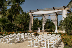 Outdoor Ceremony Structure with White Draping and Chairs