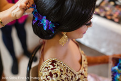 Indian bride decorating her hair with flowers. Indian bride decorating her hair with flowers.