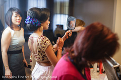 Indian bride checking her make up while getting ready. Indian bride checking her make up while getting ready.