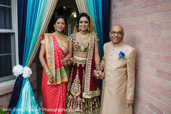 Indian bride waiting with her parents outside her home. Indian bride waiting with her parents outside her home.