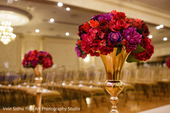 Fucsia and red flowers decorating the ceremony aisle. Fucsia and red flowers decorating the ceremony aisle.