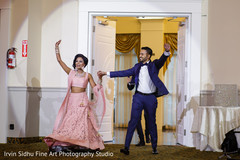Indian couple making their entrance to their wedding reception pink sari,indian bride,indian groom,indian wedding reception