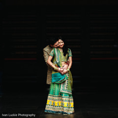 Indian engaged couple posing in green matching outfits. Indian engaged couple posing in green matching outfits.