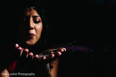 Indian bride blowing some sparkles from her bridal mehndi design. bride mehndi design,indian bride,indian bride photography