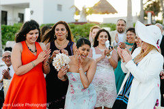 Fortunate single lady getting the bride's bouquet. indian wedding,indian destination wedding,outdoor ceremony