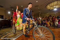 Bride and groom entering their garba in a rickshaw. rickshaw,indian wedding transportation