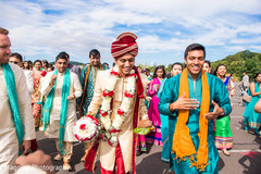 Handsome indian groom escorted by friends and family during baraat procession. Handsome indian groom escorted by friends and family during baraat procession.