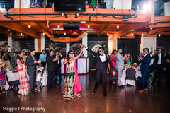 Indian bride and groom dancing white their enter their wedding party. indian wedding reception ideas,reception lengha,ndian wedding photography,indian wedding reception photography