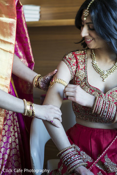 Indian bride adjusting her jewelry. Indian bride adjusting her jewelry.