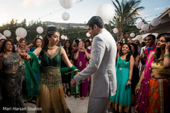 Indian bride and groom dancing at their pre-weeding beach party. Indian bride and groom dancing at their pre-weeding beach party.