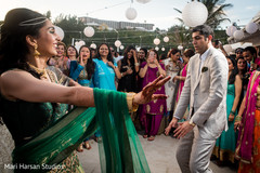 Indian bride and groom dancing at their pre-weeding beach party. Indian bride and groom dancing at their pre-weeding beach party.