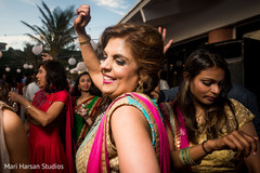 Party guest smiling and dancing at the beach party pre-wedding celebration. Party guest smiling and dancing at the beach party pre-wedding celebration.
