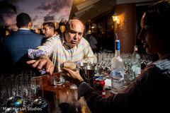 Bar tender preparing drinks in the beach party pre-indian wedding celebration. Bar tender preparing drinks in the beach party pre-indian wedding celebration.
