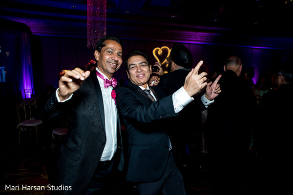 Indian wedding guests having fun during the reception.