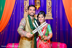 Indian bride and groom ready to dance with their garba sticks. Indian bride and groom ready to dance with their garba sticks.
