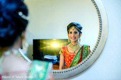 Stunning indian taking a last look to her hair and make up. Stunning indian taking a last look to her hair and make up.