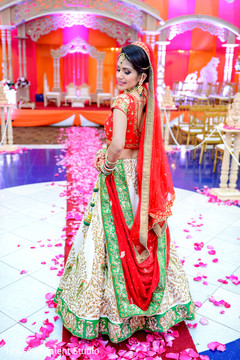 Indian bride posing in her beautiful red, green and white lengha. Indian bride posing in her beautiful red, green and white lengha.
