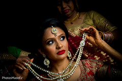 Gorgeous indian bride adjusting her bridal jewelry. Gorgeous indian bride adjusting her bridal jewelry.