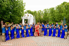 Indian couple with bridesmaids and groomsmen in golden and blue traditional outfits. blue saris,indian bridesmaids,indian groomsmen,indian wedding photography session