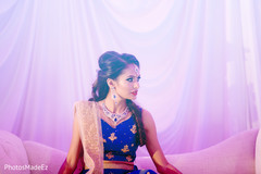 Stunning indian bride seating in the main stage at the wedding reception. Stunning indian bride seating in the main stage at the wedding reception.