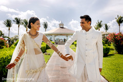 Indian bride and groom in matching white outfits. Indian bride and groom in matching white outfits.