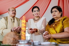 Indian bride with her parents at a pre-wedding ceremony Indian bride with her parents at a pre-wedding ceremony