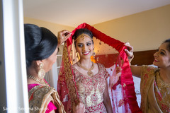 Indian bride getting some extra help before the ceremony. Indian bride getting some extra help before the ceremony.