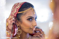 Lovely bride checking her jewelry. Lovely bride checking her jewelry.