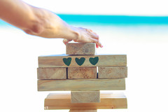 Guest playing jenga at the beach side party. Guest playing jenga at the beach side party.