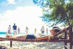 Guests relaxing and having fun at the beach side party. Guests relaxing and having fun at the beach side party.