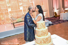 Lovely indian couple cutting their wedding cake Lovely indian couple cutting their wedding cake
