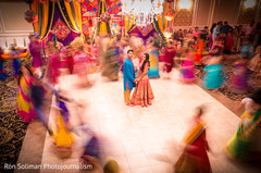 Amazing capture of indian bride and groom in the middle of the dance hall. Amazing capture of indian bride and groom in the middle of the dance hall.