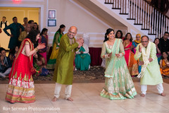 Sweet shot of guests dancing at the sangeet party. Sweet shot of guests dancing at the sangeet party.