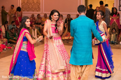 Beautiful bride to be dancing along with guests at the sangeet party. Beautiful bride to be dancing along with guests at the sangeet party.