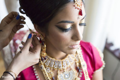 Indian bride putting her jewelry on. Indian bride putting her jewelry on.
