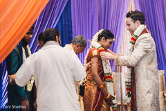 Groom exchanging jaimala Groom exchanging jaimala