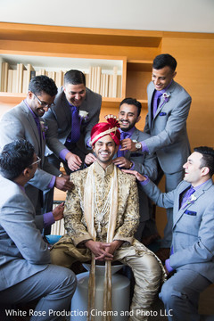 Groomsmen helping groom getting ready Groomsmen helping groom getting ready