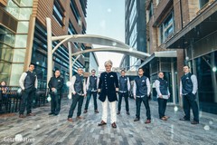 Indian groom and groomsmen standing at the plaza indian groom fashion,indian wedding shoes,indian groomsmen fashion,indian groom turban
