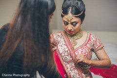 Indian bride adjusting the final details of her attire. Indian bride adjusting the final details of her attire.