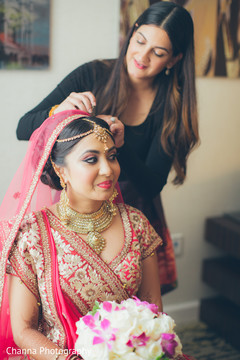 Beautiful bride getting her wedding attire adjusted. Beautiful bride getting her wedding attire adjusted.