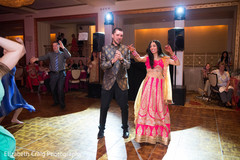 Indian couple showing off their moves at the sangeet celebration. Indian couple showing off their moves at the sangeet celebration.