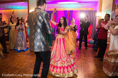 Happy couple dancing at their sangeet celebration. Happy couple dancing at their sangeet celebration.
