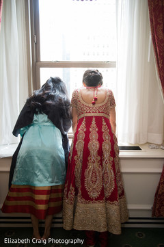 Indian bride tries to see the baraat procession. Indian bride tries to see the baraat procession.