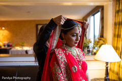 Indian bride getting some help with her dupatta. Indian bride getting some help with her dupatta.