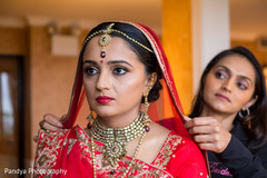 Indian bride getting the final touch ups of her outfit. Indian bride getting the final touch ups of her outfit.