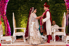 Indian couple exchanging jaimalas at wedding ceremony Indian couple exchanging jaimalas at wedding ceremony