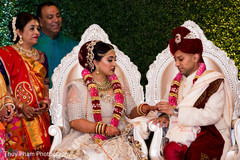 Indian couple exchanging rings at wedding ceremony Indian couple exchanging rings at wedding ceremony